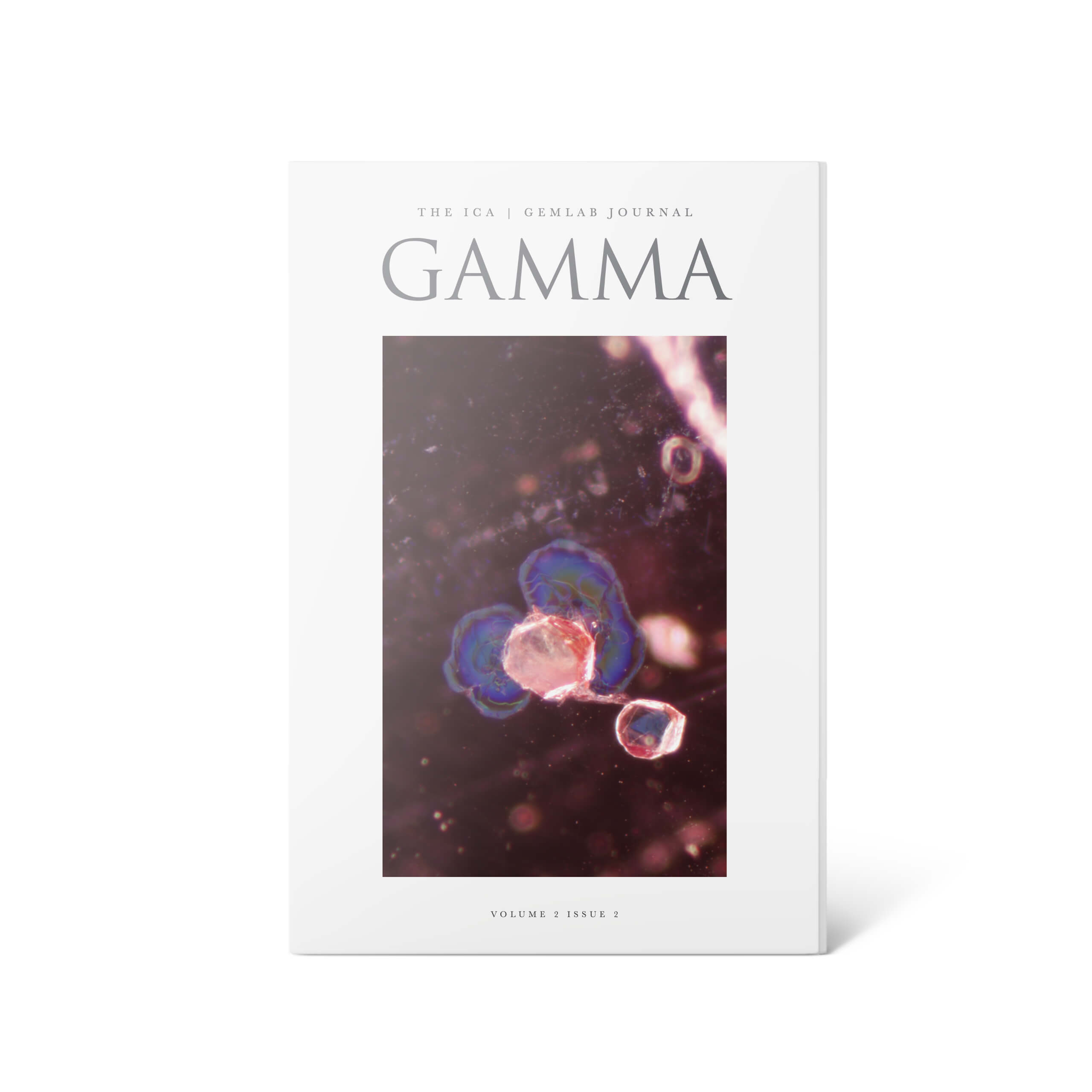 Gamma the ICA GemLab Gemmological journal. Volume 2 issue 2. Photomicrograph of an included crystal and its colourful tension halos seen within a FURA ruby from Mozambique.
