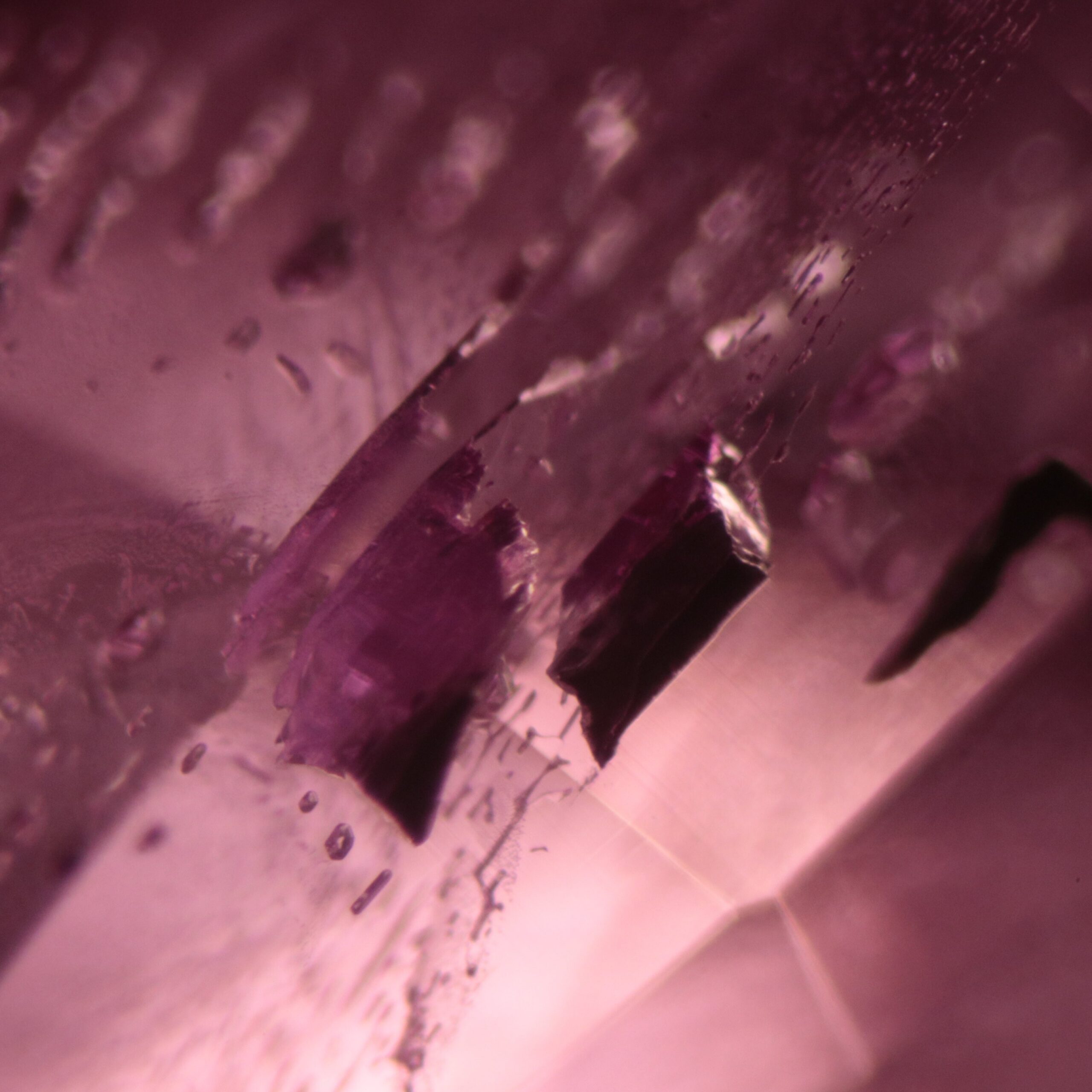Elongated blocks with high luster surface crystal inclusions in natural pink sapphire